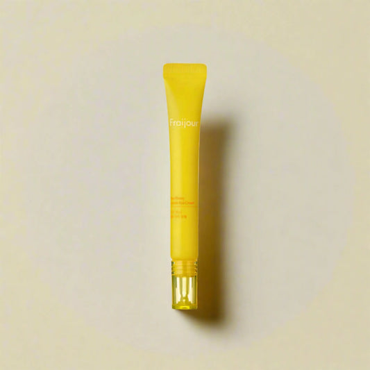 Fraijour Yuzu Honey Capsule Eye Cream 15ml, με το προϊόν να φαίνεται καθαρά, προσφέρει αντιγηραντική φροντίδα και αναζωογόνηση για τα μάτια.